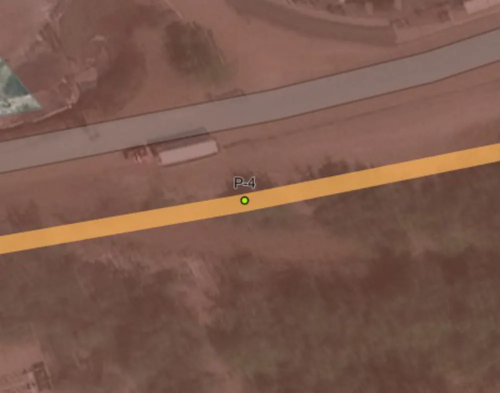 The same stretch of line on April 2, 2025, after trimming: the road, the pole and the orange line remain, and no encroachment points are left.