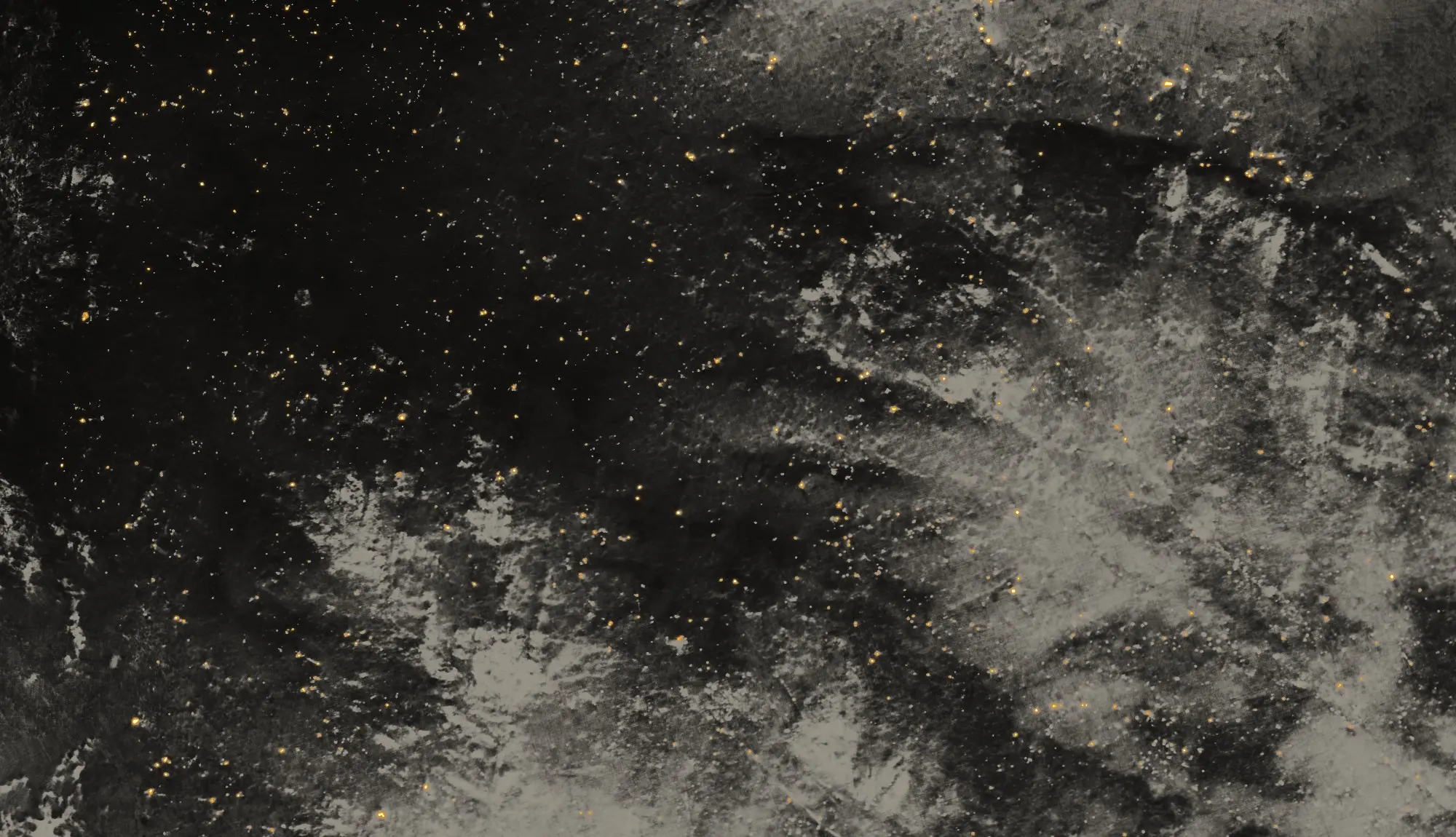 Night thermal mosaic of a burned hillside in Oregon from a drone flight: black, cooled ground scattered with hundreds of small orange and yellow points, each a hot spot the camera measured, and paler, warmer unburned ground to the right.